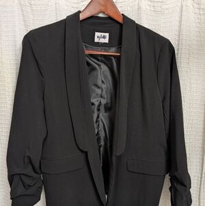Black blazer with a shawl collar by the brand Vylette